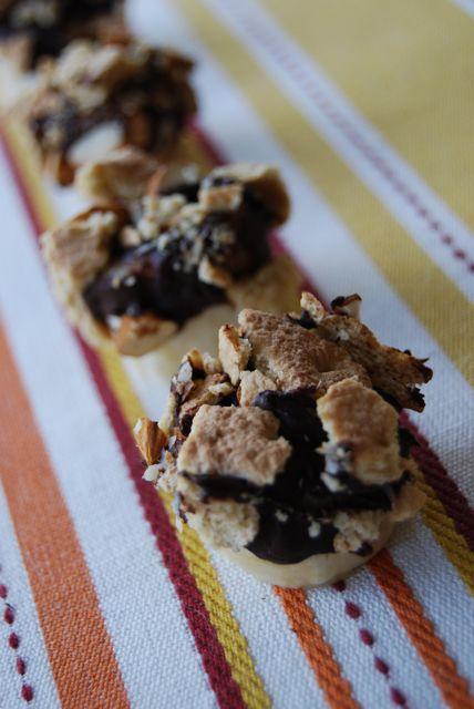 Banana slices dipped in chocolate and topped with almonds and graham crackers make a delicious, healthy, kid-friendly snack!