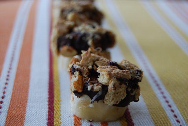 Banana slices dipped in chocolate and topped with almonds and graham crackers make a delicious, healthy, kid-friendly snack!
