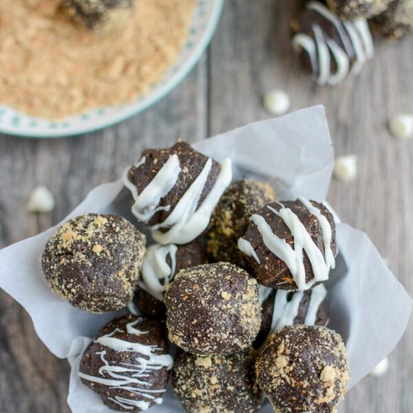 These Peanut Butter Chocolate Truffles are the perfect holiday dessert. Made with just four simple ingredients, they're easy to make and deliciously rich. Roll them in graham crackers or drizzle with chocolate to make them a little fancier!