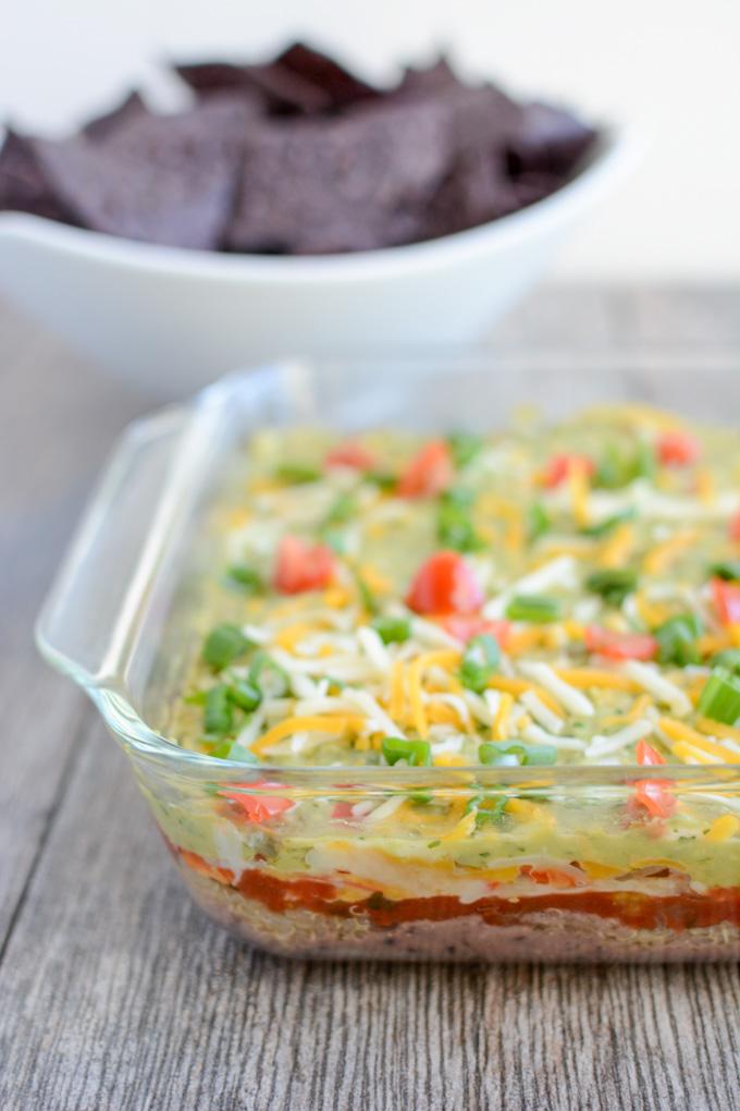 This recipe for Hot Mexican Layer Dip is an easy, healthy appetizer that's perfect for parties, game days and other gatherings. Plus it's full of protein thanks to the quinoa, cottage cheese and black beans so you can feel good about eating it!