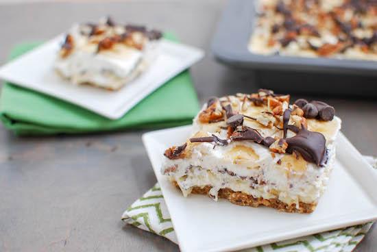 A fun twist on traditional, these Banana Cream Pie Bars are made with homemade vanilla pudding and whipped cream, plus fresh bananas and lots of pecans, peanut butter and chocolate for a delicious dessert. 