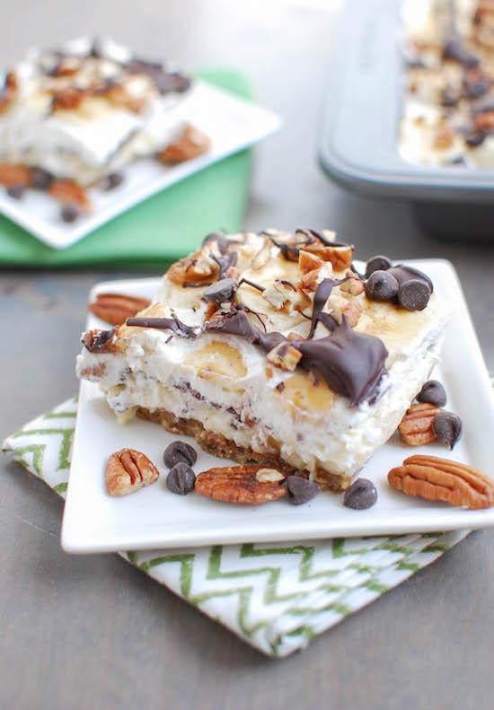 A fun twist on traditional, these Banana Cream Pie Bars are made with homemade vanilla pudding and whipped cream, plus fresh bananas and lots of pecans, peanut butter and chocolate for a delicious dessert. 