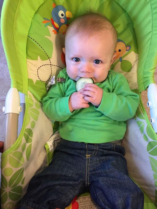 baby with cucumber