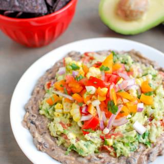 This Mexican Layer Dip is easy to make and full of flavor! With layers of spicy black bean dip, homemade guacamole and fresh corn salsa it's the perfect party appetizer or snack!
