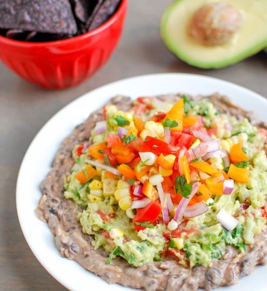 This Mexican Layer Dip is easy to make and full of flavor! With layers of spicy black bean dip, homemade guacamole and fresh corn salsa it's the perfect party appetizer or snack!