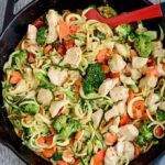 Zucchini Noodles with Chicken and Spicy Almond Butter Sauce in cast iron skillet