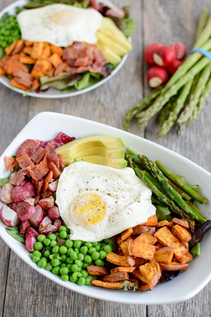 Loaded with spring vegetables and topped with over-easy eggs, this paleo, gluten-free Spring Breakfast Salad is an easy and delicious way to start your day with more veggies!