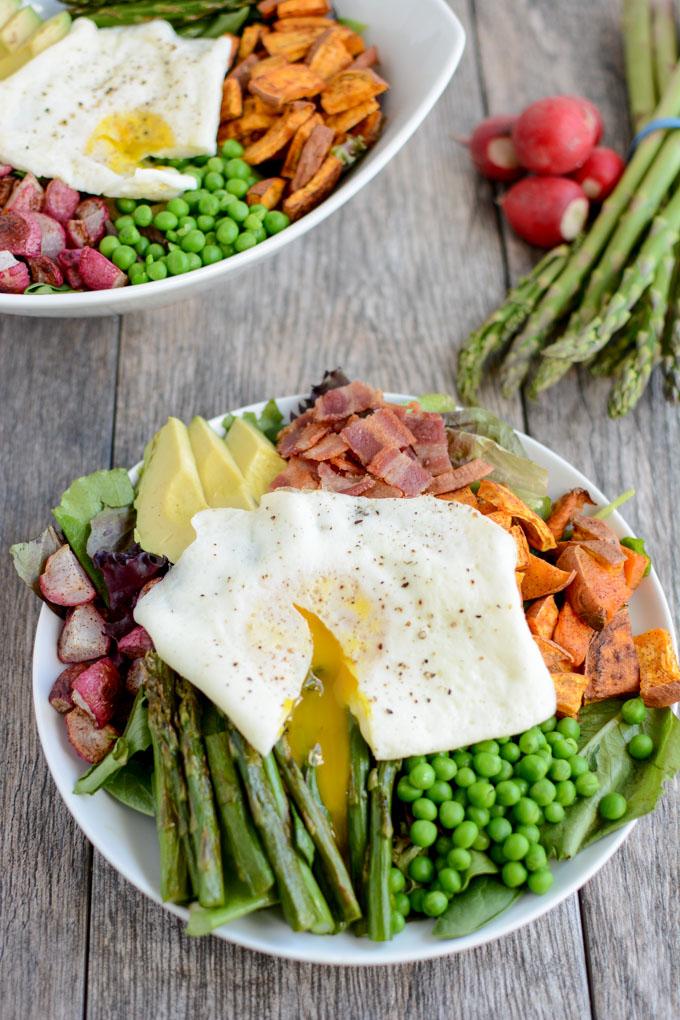 Loaded with spring vegetables and topped with over-easy eggs, this paleo, gluten-free Spring Breakfast Salad is an easy and delicious way to start your day with more veggies!