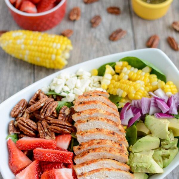 This Strawberry Chicken Spinach Power Salad is perfect for summer! It's packed with protein, fresh produce & nuts and topped with a lemon poppyseed dressing. A great recipe for lunch or dinner!