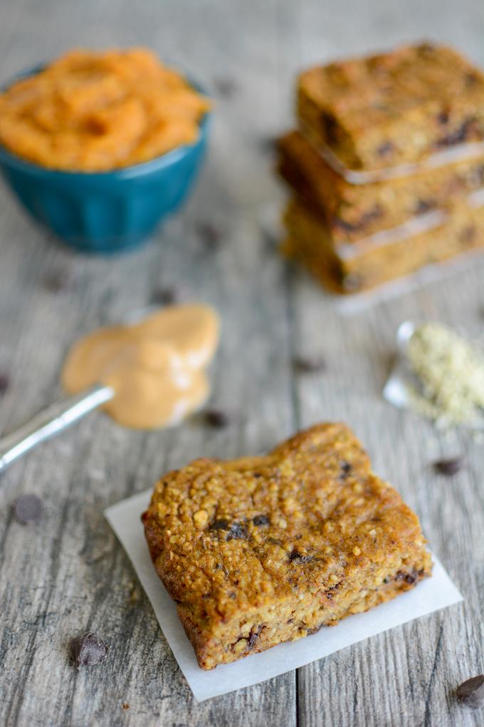 Gluten-free pumpkin yogurt bars with a spoonful of peanut butter and bowl of pumpkin