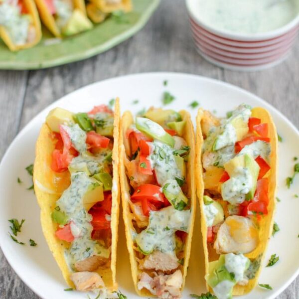 These gluten-free Baked Chicken Tacos with Creamy Cilantro Sauce will quickly become a favorite family dinner recipe!