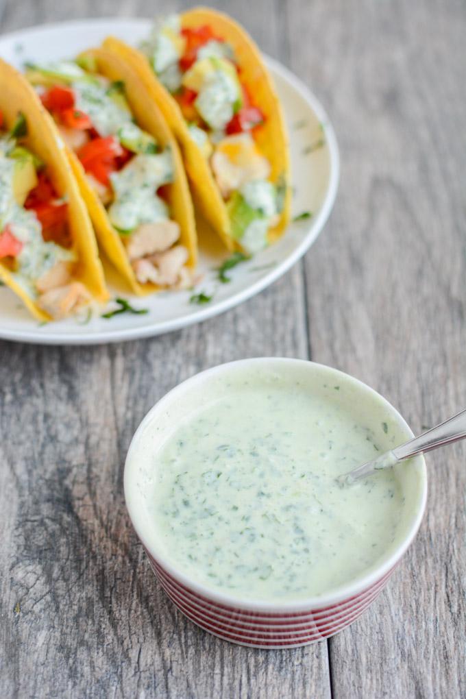These gluten-free Baked Chicken Tacos with Creamy Cilantro Sauce will quickly become a favorite family dinner recipe! 