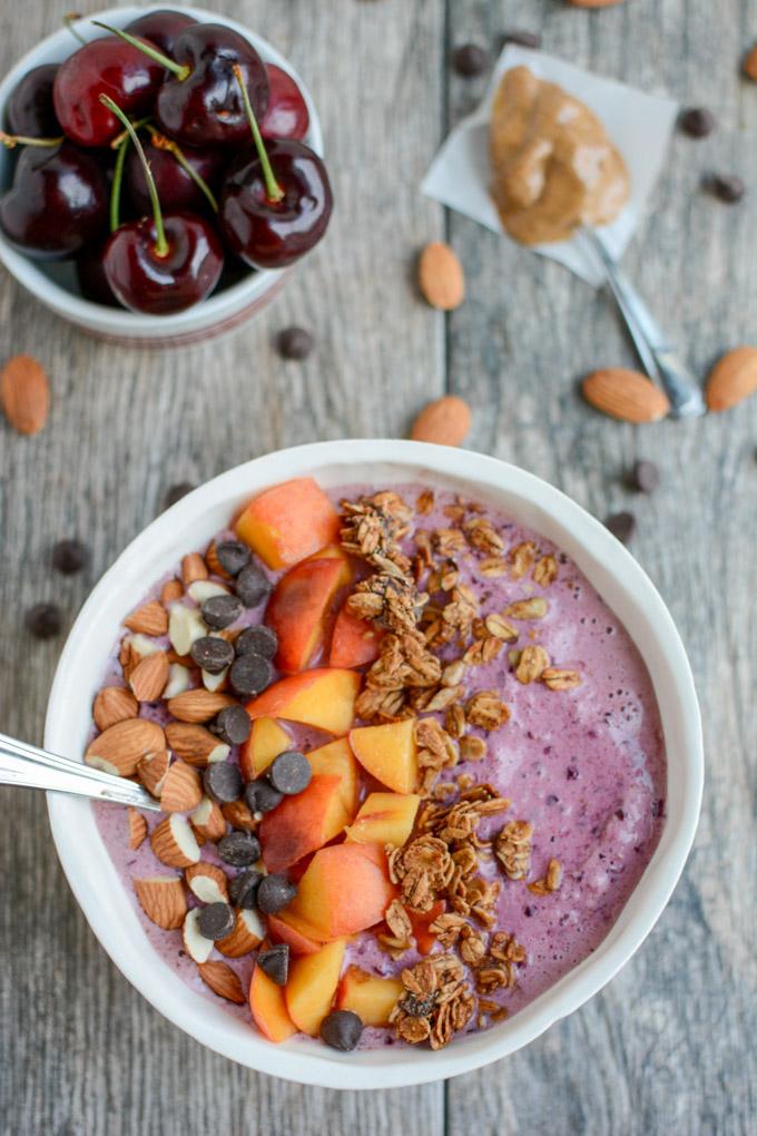 This Cherry Almond Smoothie Bowl recipe is full of healthy fats and protein for a healthy breakfast or snack on a hot day. Top with granola and nuts for an added crunch and dig in with a spoon!