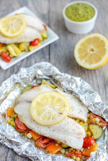 This recipe for Grilled Foil Packet Tilapia with Pesto Veggies is perfect for a summer dinner! It's quick, easy and healthy, plus cleanup is a breeze!