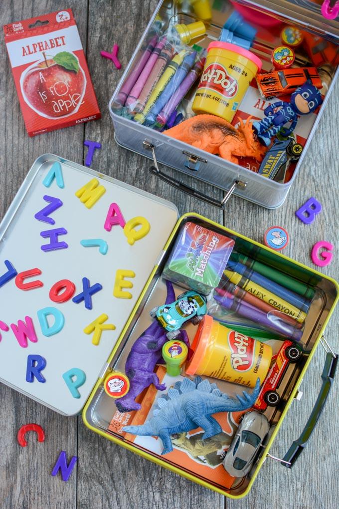 Learn how to make a busy box for toddlers. These boxes are easy to customize and perfect for keeping toddlers occupied at a restaurant, on a plane, while mom is nursing and more!