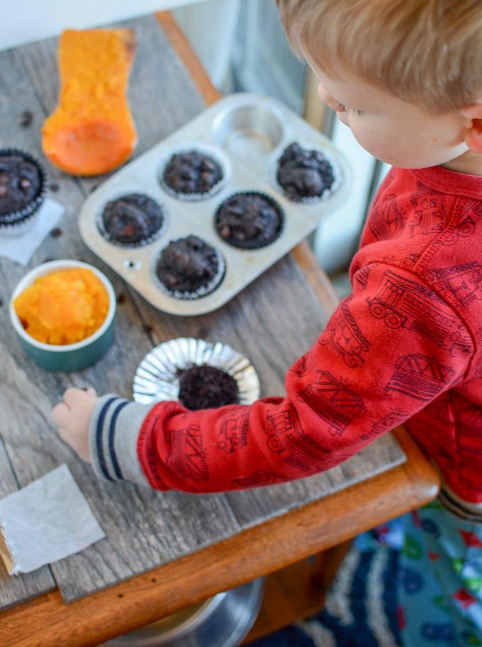 Toddler eating Chocolate Squash Muffin