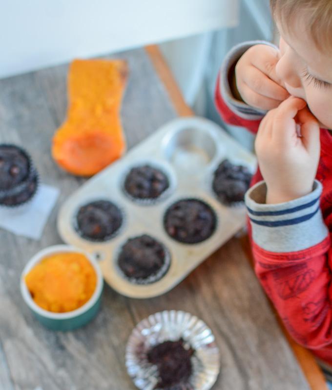 kid eating chocolate butternut squash muffin