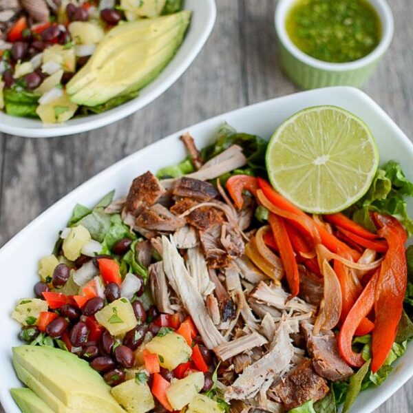 This Pulled Pork Fajita Salad is the perfect way to transform leftover pulled pork into a healthy new lunch or dinner. A pineapple black bean salsa and a light cilantro-lime dressing add extra flavor!