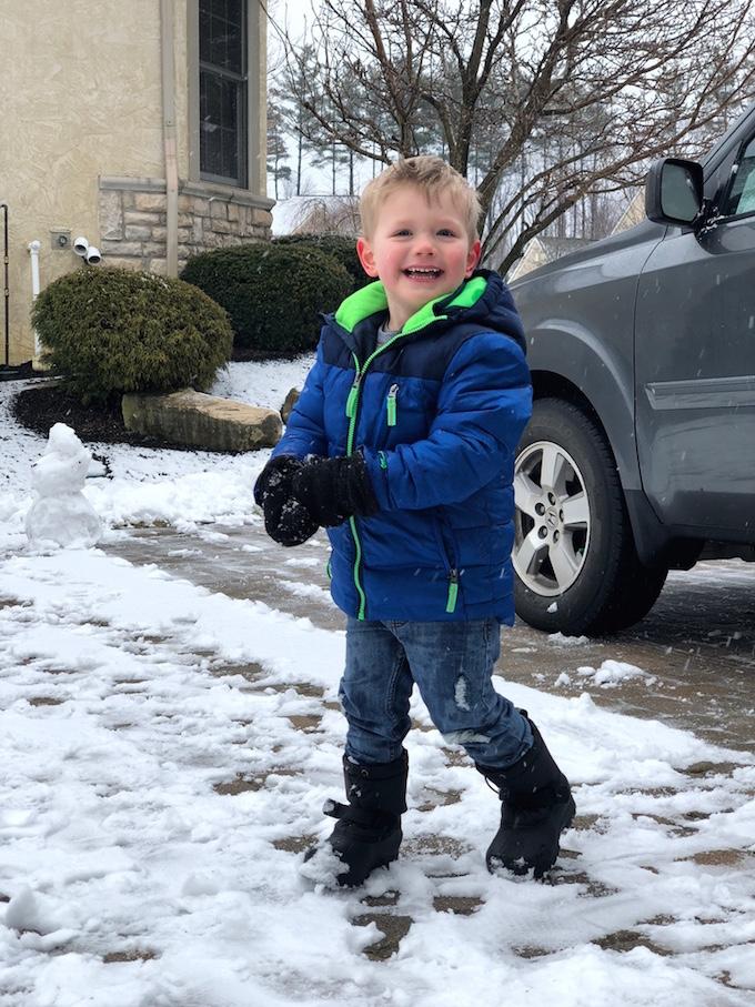 toddler throwing snow