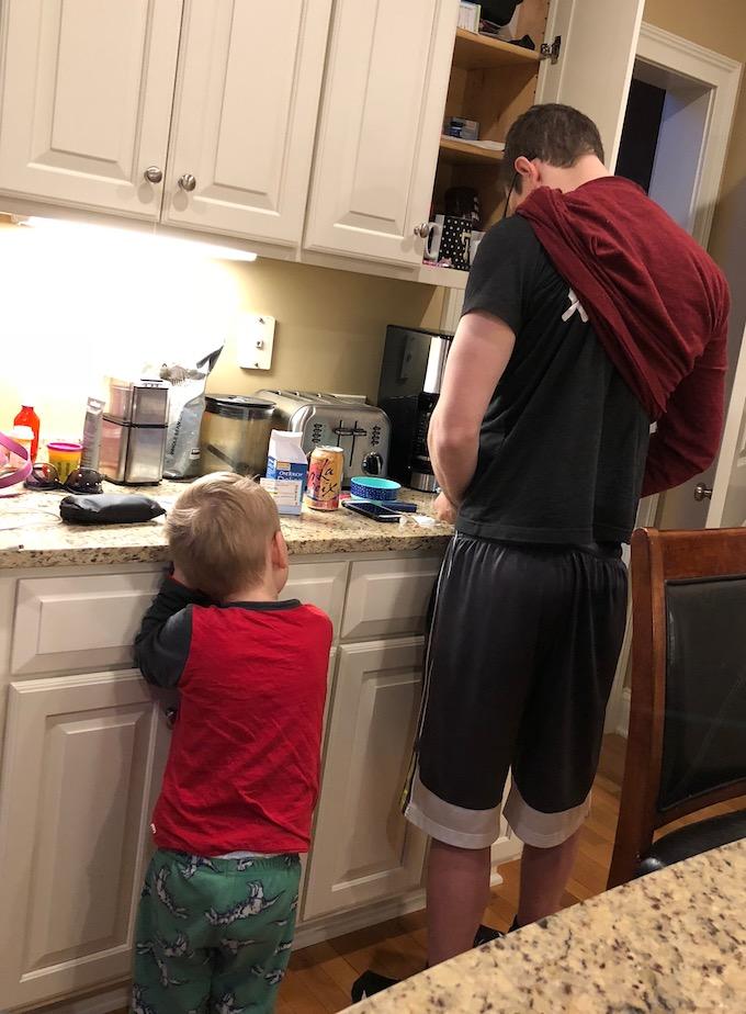 toddler watching dad check blood sugar