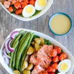 This Salmon Nicoise Salad is an easy, flavorful twist on a classic recipe. Made with roasted vegetables, baked salmon and a simple dressing, it's perfect for a healthy lunch or dinner!
