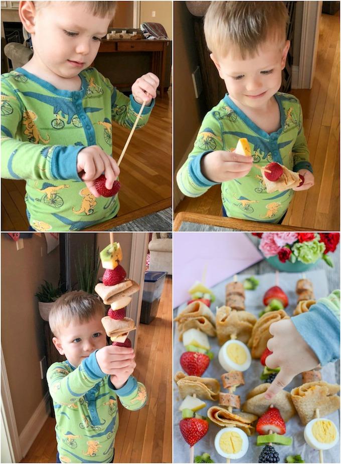 Toddler assembling fruit crepe kabobs