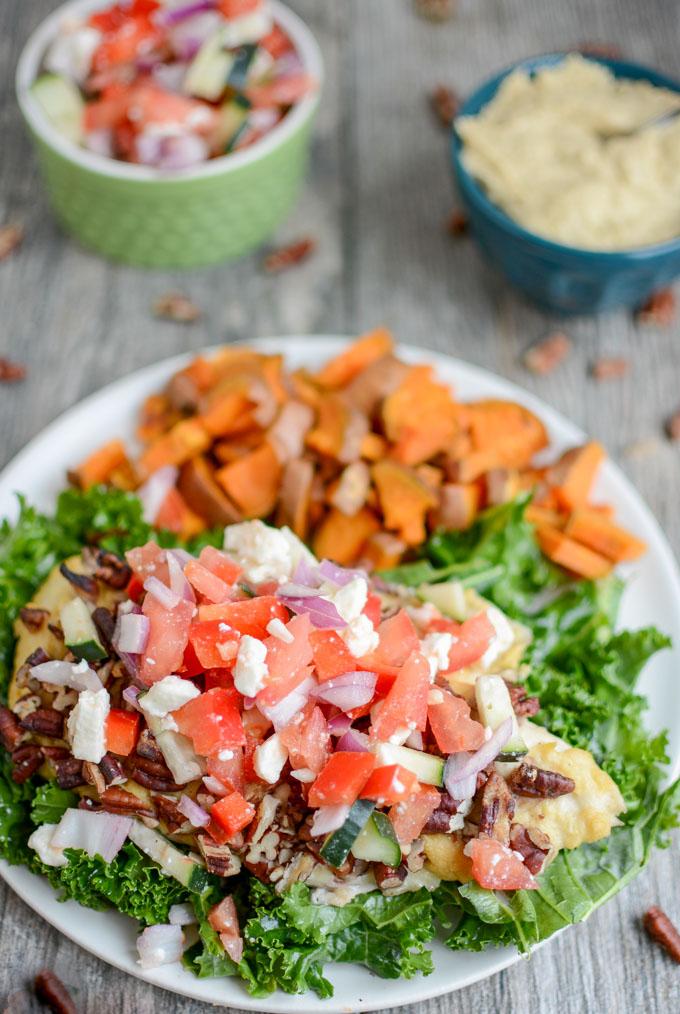 Hummus Crusted Chicken topped with feta and tomato mixture