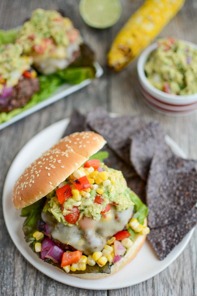 Mexican Burgers topped with grilled corn salsa, pepperjack cheese and guacamole