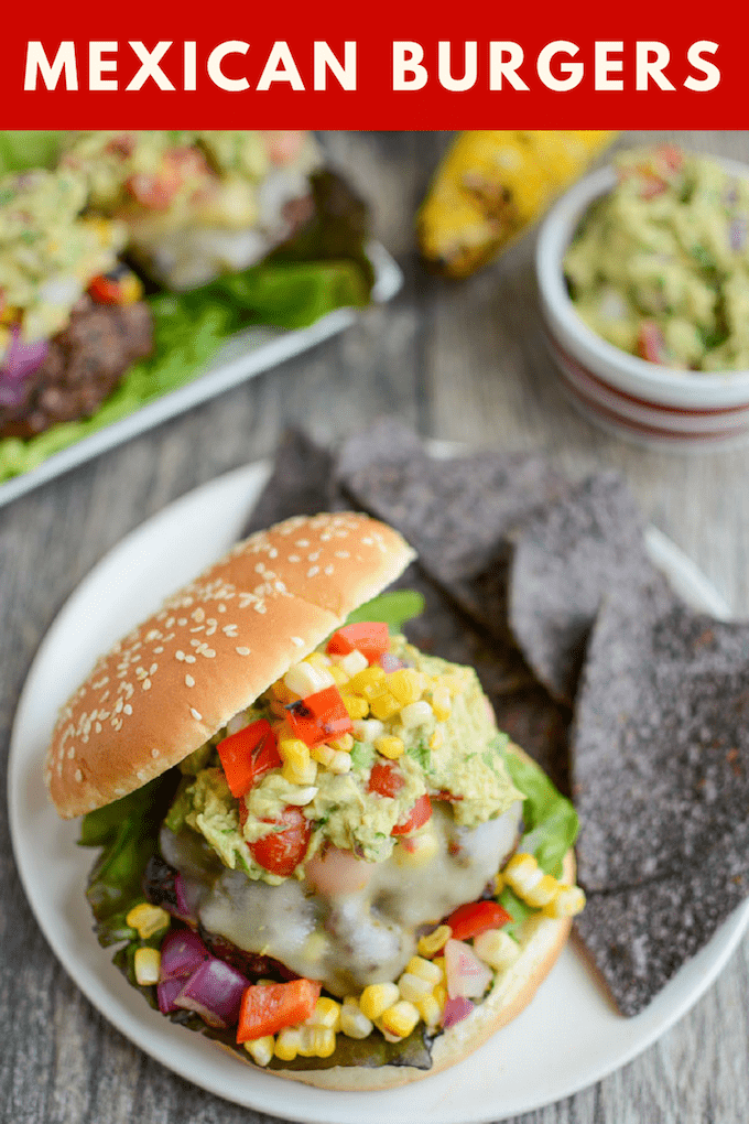 These Mexican Burgers are perfect for your summer cookout or party. Topped with grilled corn salsa, pepperjack cheese and lots of guacamole, each bite is packed with flavor!