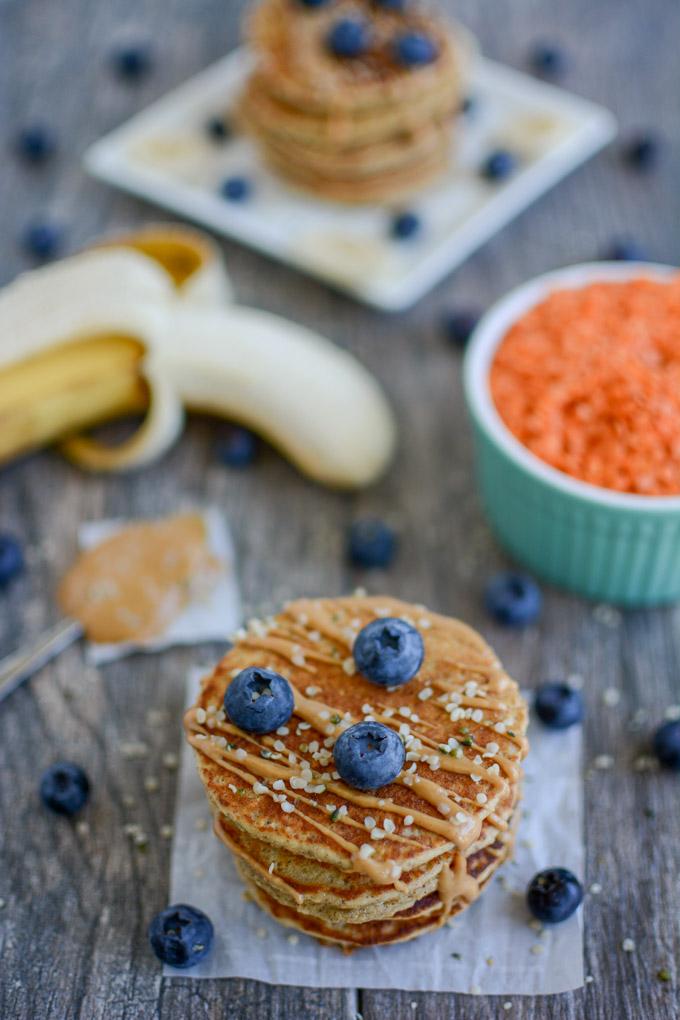 Red Lentil Pancakes topped with blueberries and peanut butter