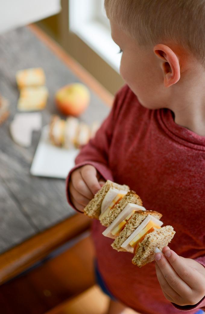 toddler eating sandwich kabob