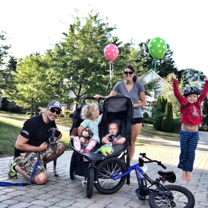 family celebrating walking and biking 100 miles over the summer