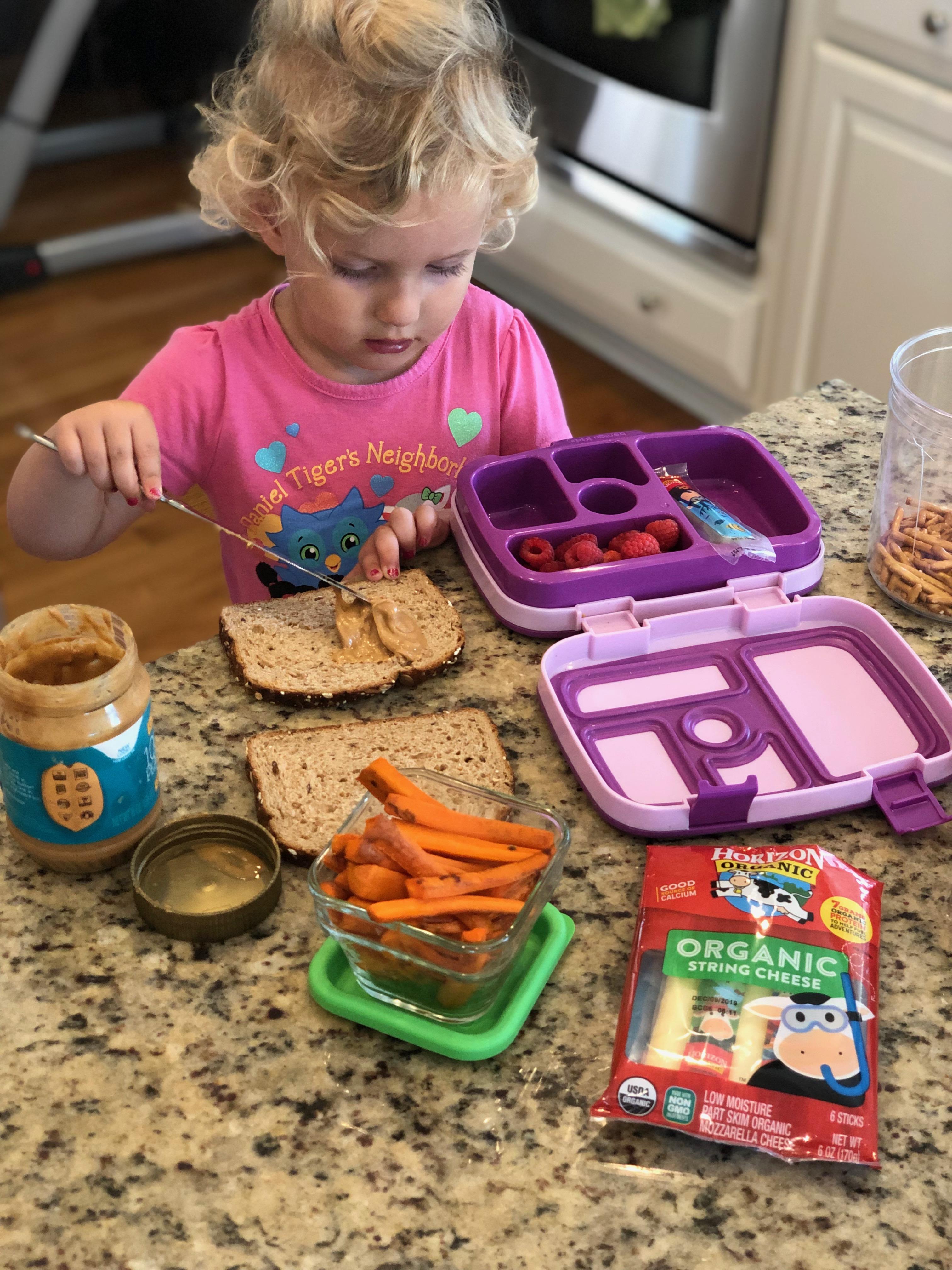 2 year old making sandwich for school lunch