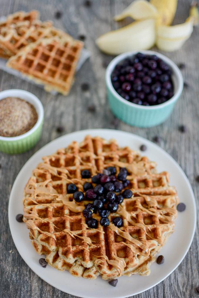 Banana Flax Waffles topped with blueberries and peanut butter