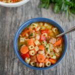 Sausage and white bean soup with noodles, carrots and peppers