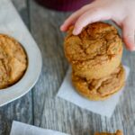 toddler hand grabbing carrot applesauce muffin