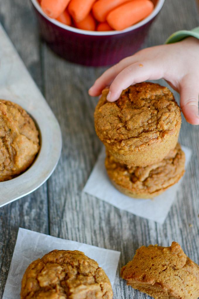 toddler hand grabbing carrot applesauce muffin