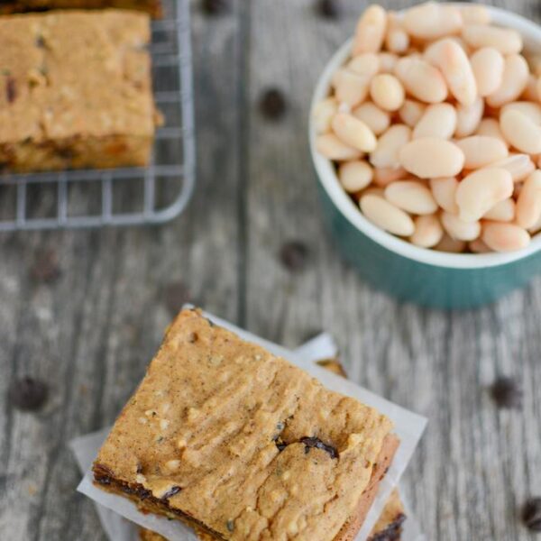 Sweet Potato White Bean Bars - stacked, on cooling rack and a bowl of beans