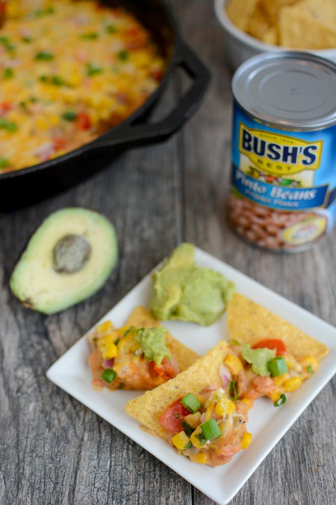 hot taco layer dip on chips with guacamole