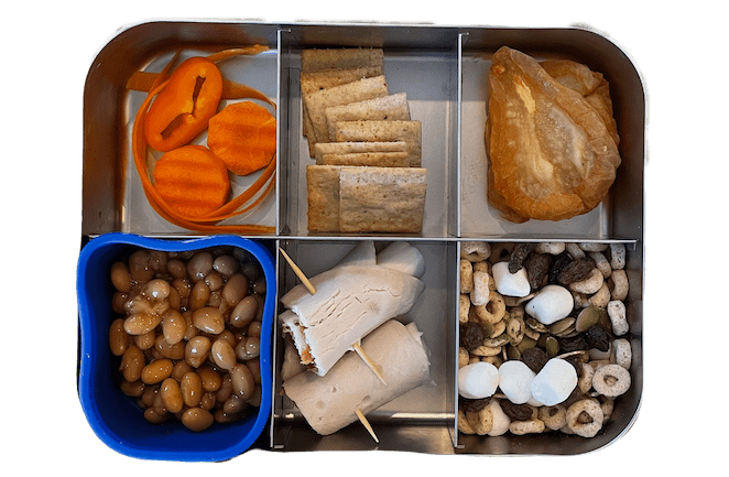 lunch box for kids with baked beans, turkey cheese roll up, trail mix and dried pears