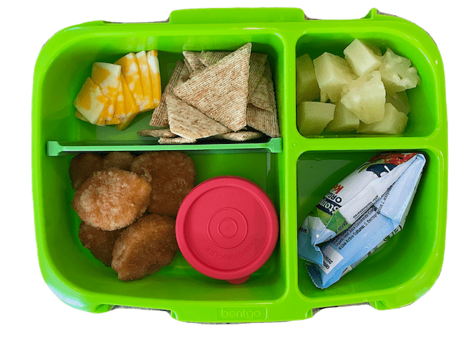 kids lunch box idea - chicken nuggets, yogurt tube, cheese and crackers and fruit