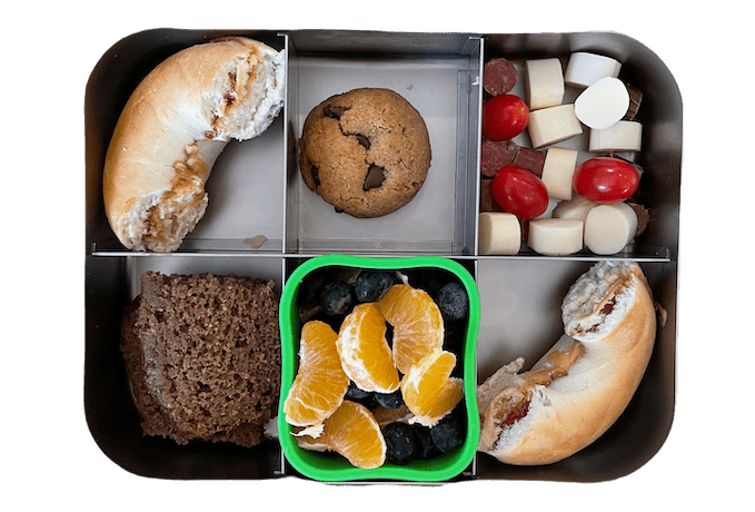 Easy Lunch Box Ideas For Kids 10 kids lunch box with peanut butter and jelly bagel, fruit salad, banana bread and cookie