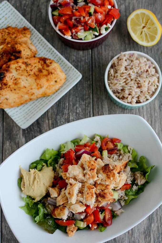 Simple Chicken Marinade for Meal Prep 3 marinated meal prep chicken plated on salad with rice
