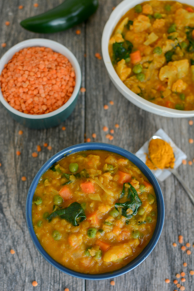 two bowls of spicy vegan red lentil curry