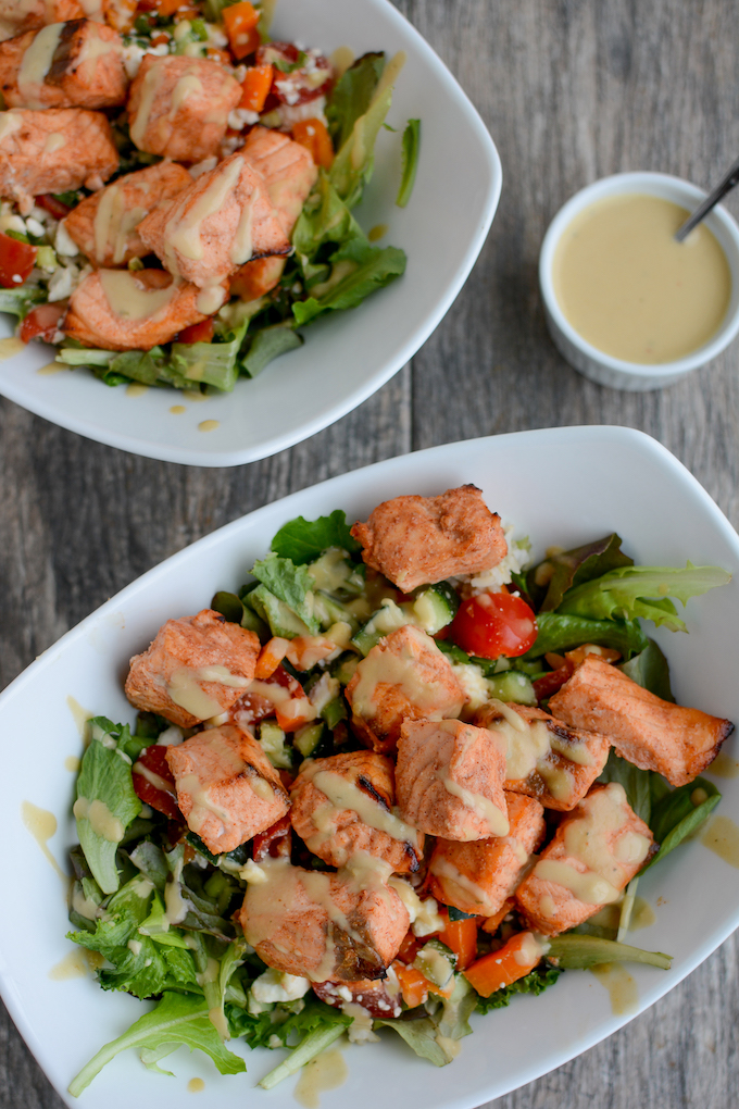 Air fryer salmon bites over greek salad. Delicious salmon chunks in air fryer.