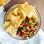 plate of cowboy caviar with avocado and tortilla chips